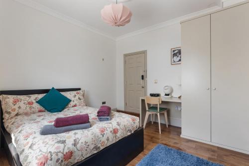 a bedroom with a bed and a table and a desk at Royal Greenwich Hospitality in London