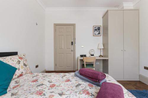 a bedroom with a bed and a desk at Royal Greenwich Hospitality in London