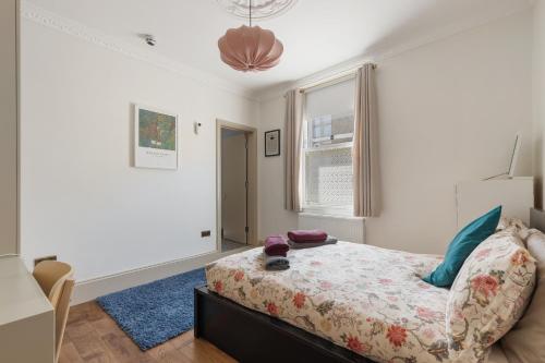 a bedroom with a bed and a window at Royal Greenwich Hospitality in London