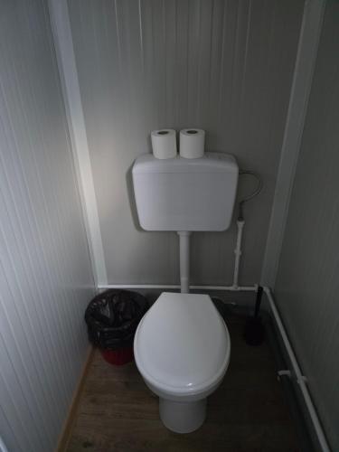 a small bathroom with a toilet and two rolls of toilet paper at Glamping Costinești in Costinesti