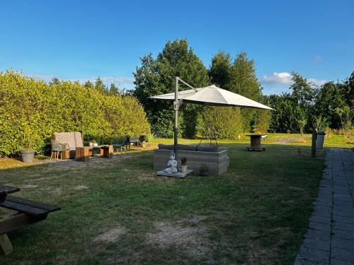 an umbrella sitting in the middle of a yard at Bell Tent in Elim