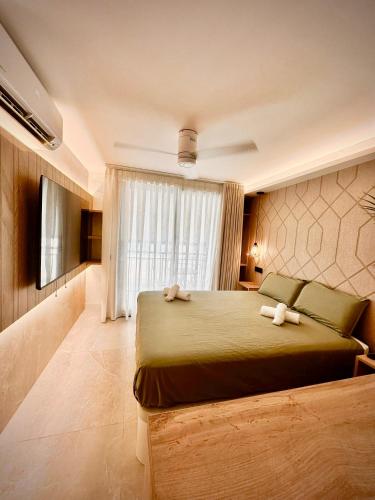a bedroom with a bed with two stuffed animals on it at SUITE PLAYA CARIHUELA Apartamentos in Torremolinos