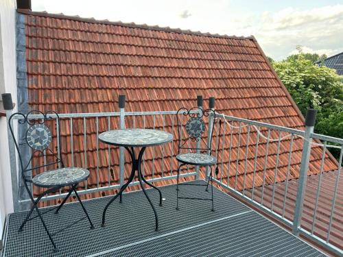 two chairs and a table on a balcony at Gasthaus Bergmann in Rahden