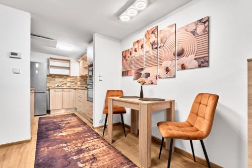 a kitchen with a table and two chairs at Apartmán Reny in Sokolov