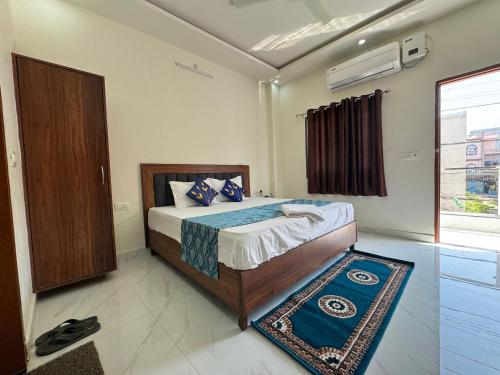 a bedroom with a bed and a window and a door at Shree Hanumat Kripa Dham in Vrindāvan