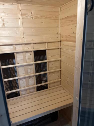 a wooden sauna with wooden racks in it at Waldblick Gästezimmer in Sonnenbühl