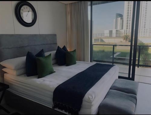 a bedroom with a large bed with a clock on the wall at Executive apartment Umhlanga in Durban