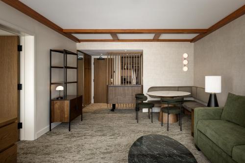 a living room with a couch and a table at Banff Park Lodge in Banff
