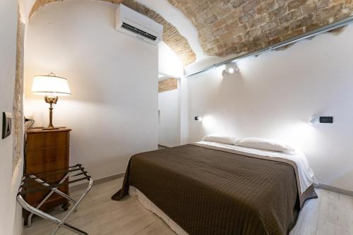 a bedroom with a bed in a white room at Rooms in the Old town in Termoli