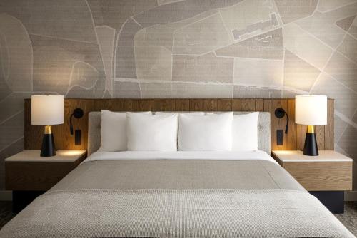a bedroom with a large bed with two lamps at Banff Park Lodge in Banff