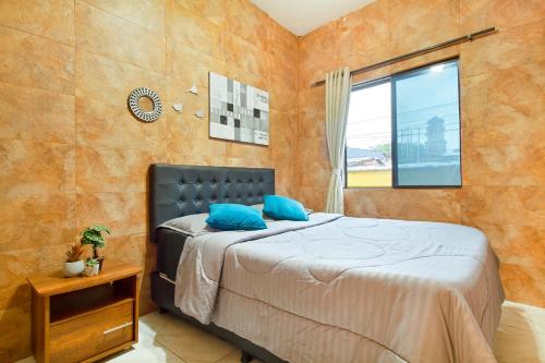 a bedroom with a bed with blue pillows on it at 5 Bedroom - 1 Block from Lleras - P2 in Medellín