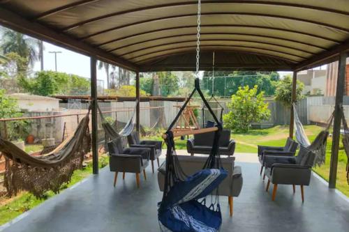 a group of hammocks hanging from a pergola at Casa Modernista - Aluguel de Suítes in Brasilia