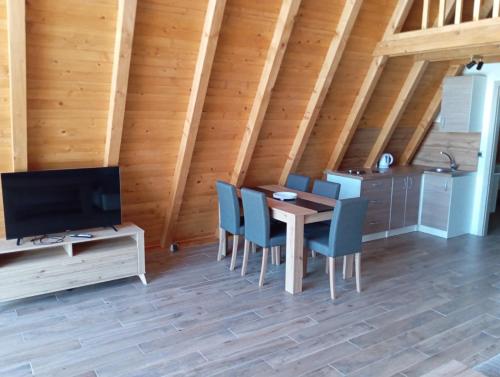 a dining room with a wooden table and chairs at Villa Rustic 