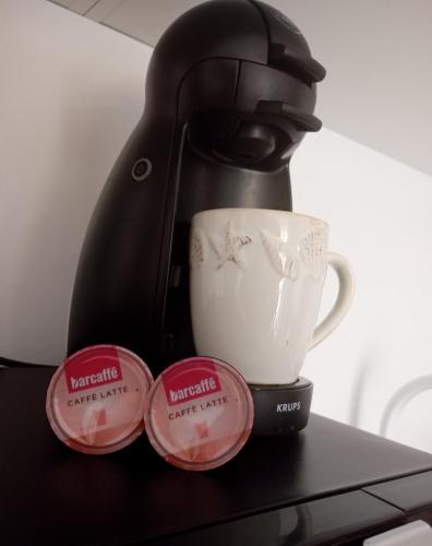 a coffee maker with three cups on a table at Lara Sea View apartment in Nea Kalikratia