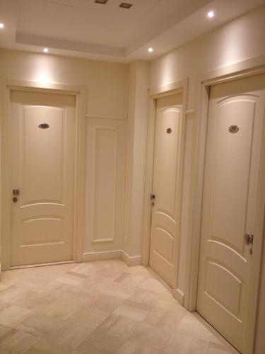 a room with two doors and a tile floor at Hotel Villa Igea in Alassio