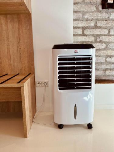 a white heater in a room with a brick wall at Adlzreiter City Pension in Munich