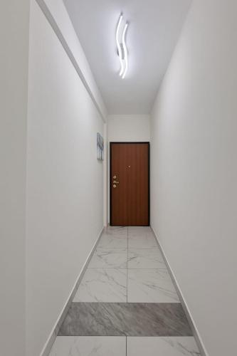 a corridor with a door in a white room at Marilissa Home in Bari