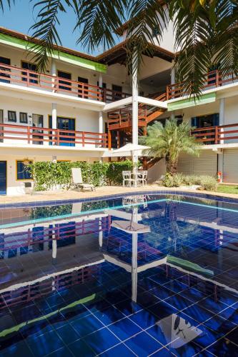 a swimming pool in front of a hotel at Pousada Dona Emilia in Brotas