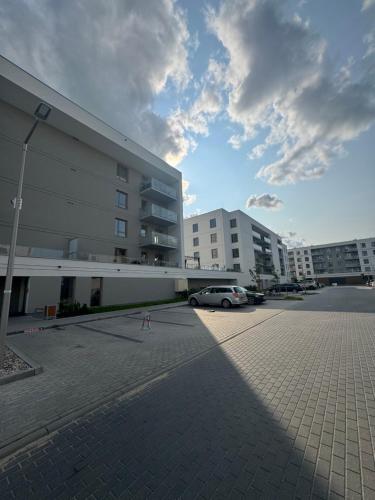 a car parked in a parking lot next to a building at Sweet Dreams Apart in Szczytno