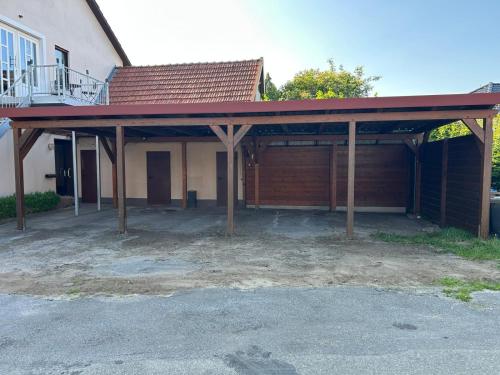 a detached garage with a red roof on a house at Gasthaus Bergmann in Rahden