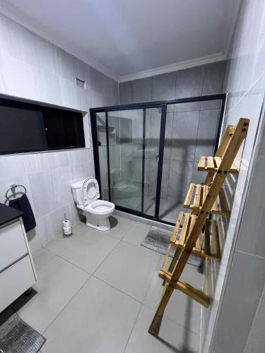 a bathroom with a toilet and a glass shower at 1 bed apartment with pool & gym in Mpemba