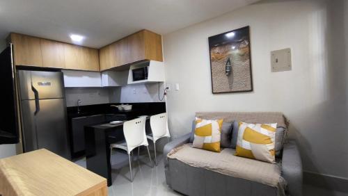 a small kitchen with a couch and a table in a room at Apartamento a beira mar in Natal