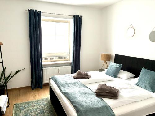 a bedroom with two beds and a window at LYMA Suites - Family Suite S34 in Immenstadt im Allgäu