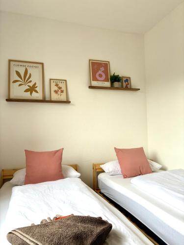 two beds sitting next to each other in a room at LYMA Suites - Family Suite S34 in Immenstadt im Allgäu