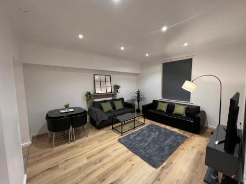 a living room with a couch and a table at 2BR Apartment - LuxeSuites - City Centre in Midland