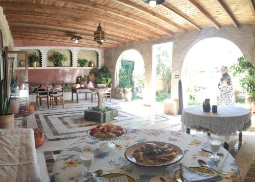 a living room with a table with food on it at Maison d'hotes in Tangier
