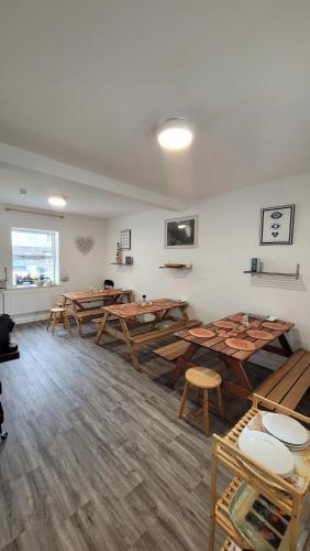 a room with wooden tables and chairs in it at The Nest at Strandhill in Strandhill
