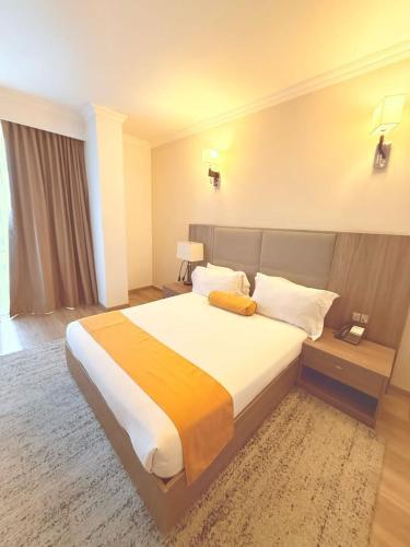 a bedroom with a large bed in a hotel room at TH BonRoyal Hotel in Addis Ababa
