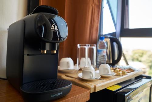 a coffee maker sitting on top of a table at Almadies Prestige in Parakou