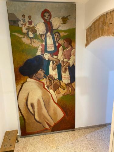 a large painting on a wall in a hallway at Apartments Loket No 59 se zahradou in Loket