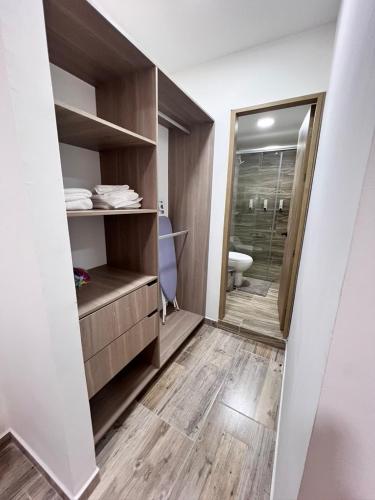 a bathroom with a toilet and a walk in shower at Meraki Urban Lofts in Quibdó