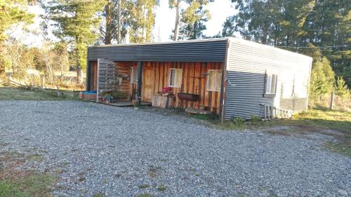 a small shed sitting on the side of a gravel road at Cabaña Cunco parcela in Cunco