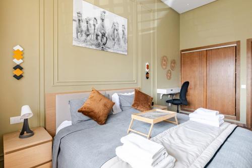a bedroom with a bed with a table on it at Cozy studio 5 min Casa port Parking Netflix in Casablanca