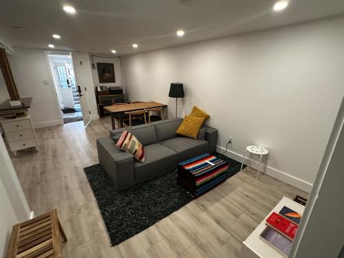 a living room with a couch and a table at The Orange Door Bungalow- 2-BR w private yard, walkable to cafes & restaurants, 10 min to DT in Vancouver