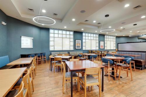 a dining room with wooden tables and chairs at Drury Inn & Suites Dayton North in Dayton