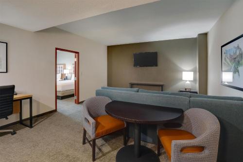 a living room with a couch and a table at Drury Inn & Suites Dayton North in Dayton