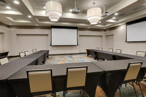 a conference room with tables and chairs and a whiteboard at Drury Inn & Suites Dayton North in Dayton