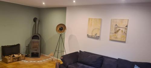 a living room with a couch and a tv at Apartment Summer Garden in Trassem