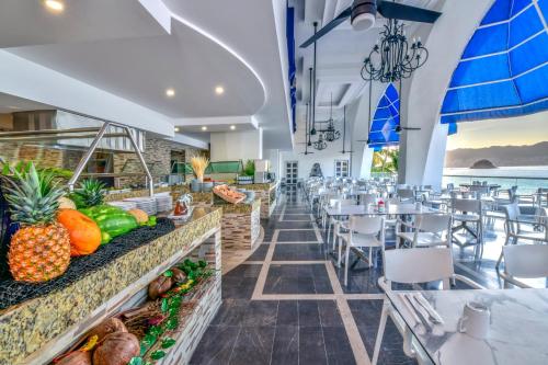 a view of a restaurant with tables and chairs at Krystal Beach Acapulco in Acapulco
