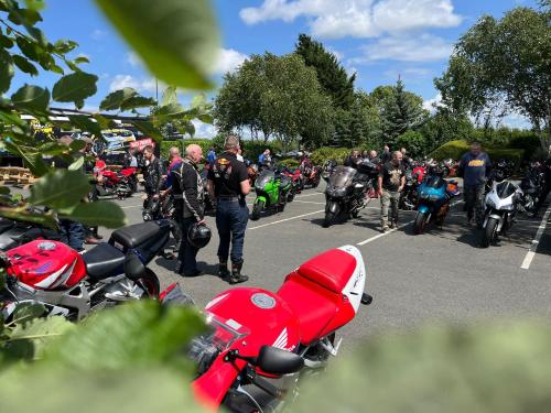 a group of motorcycles parked in a parking lot at The Stag Rooms in Stratford-upon-Avon