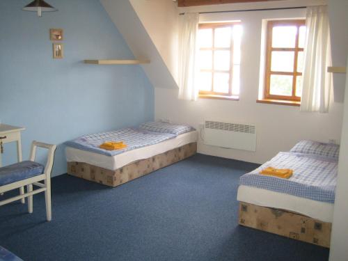 En eller flere senge i et værelse på Penzion Paták