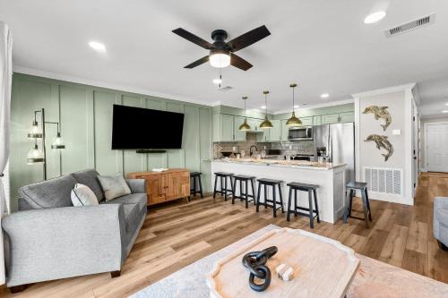 a living room with a couch and a kitchen at C' Salt 10B in Destin