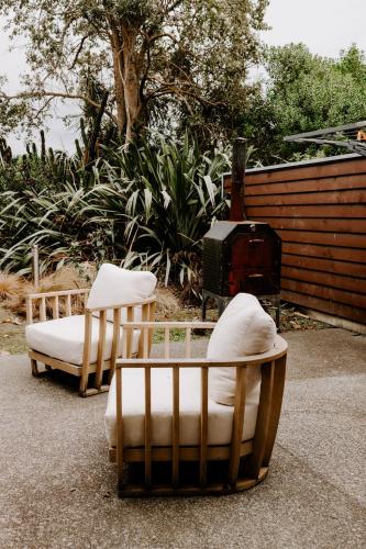two chairs and a couch sitting on the ground at Te Mata Views Resort in Havelock North