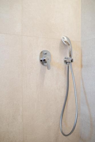a shower head on a wall in a bathroom at PALELIA living in the olive garden in Nafplio