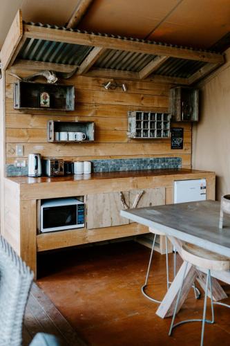 a kitchen with a wooden counter with a table and a tableablish at Te Mata Views Resort in Havelock North