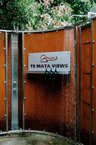 a sign that says t maia views hanging on a fence at Te Mata Views Resort in Havelock North